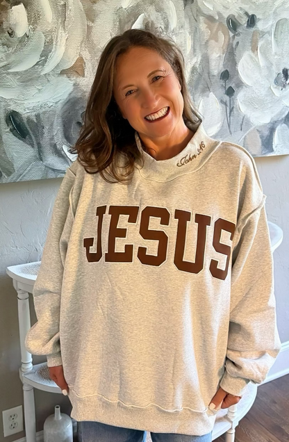 EMBROIDERED “JESUS” APPLIQUÉ MOCK-NECK SWEATSHIRT
