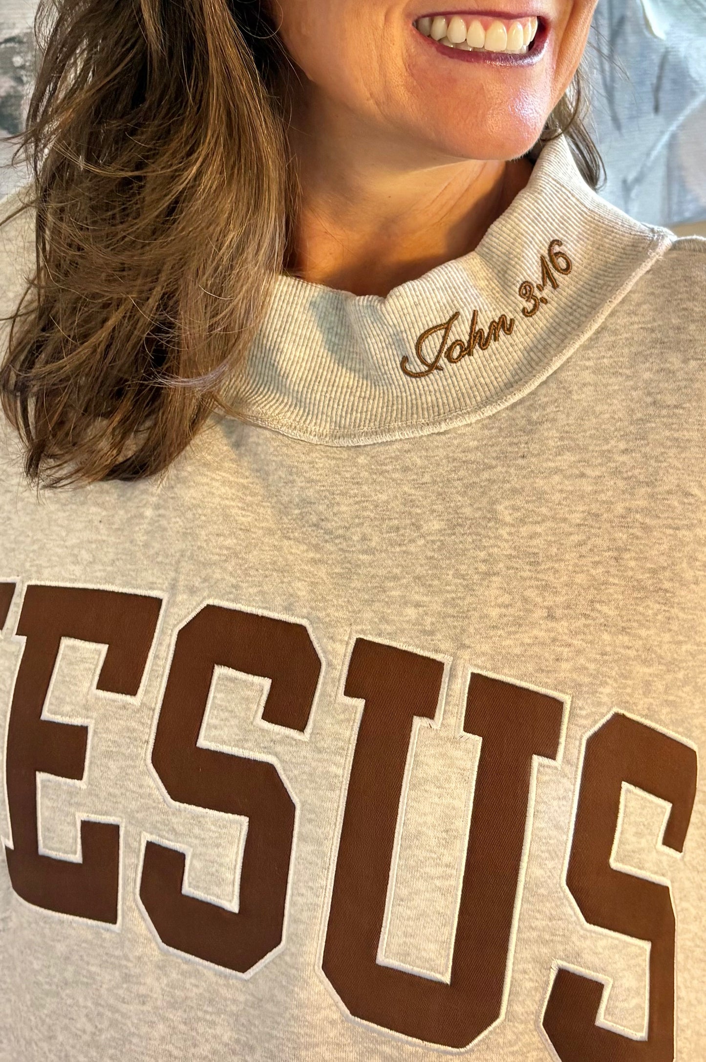 EMBROIDERED “JESUS” APPLIQUÉ MOCK-NECK SWEATSHIRT